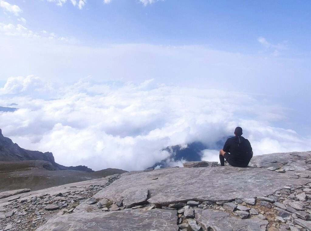 a man sitting on a rock