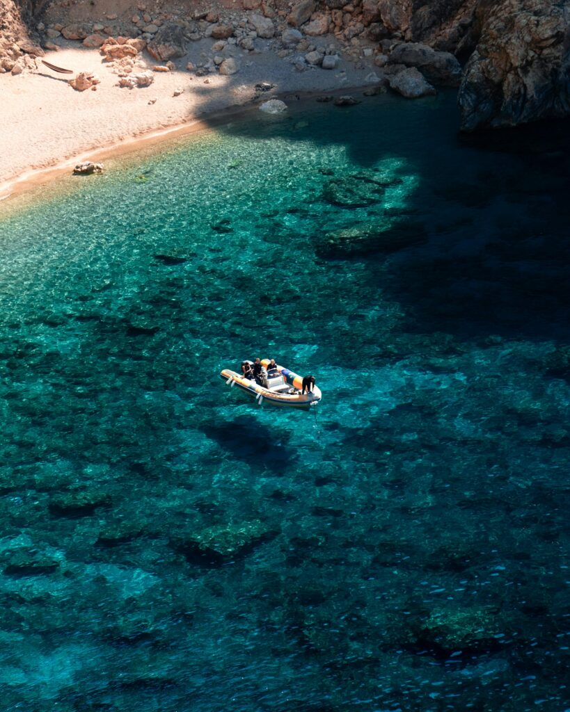 a couple of people in a small boat on a body of water