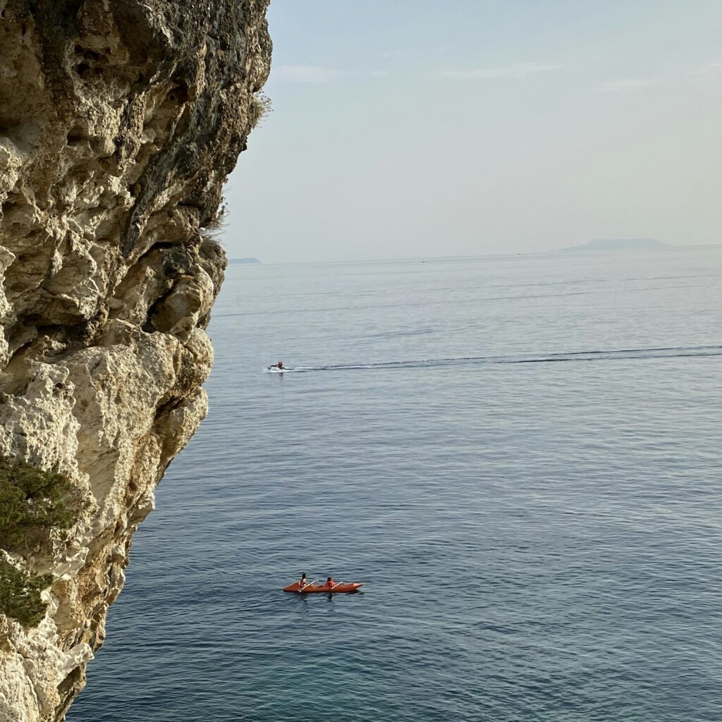 a person in a kayak in the middle of a body of water