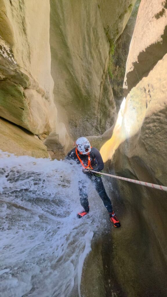 Canyoning in Greece with a guided rope descent through a gorge surrounded by natural scenery.